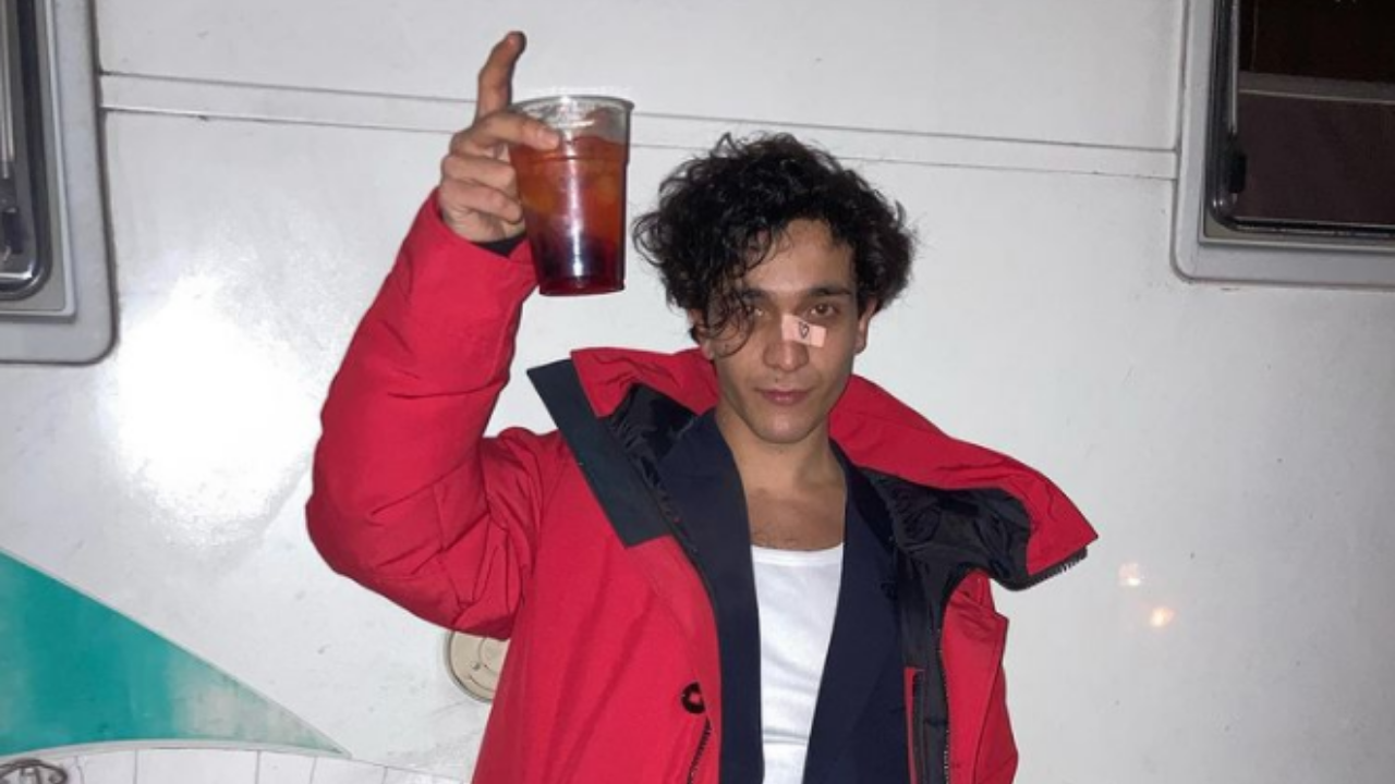 Il cantante Tananai con un bicchiere in mano